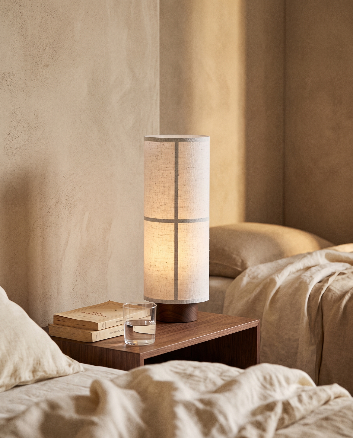 Washi table lamp lit on a bedside nightstand in a serene bedroom