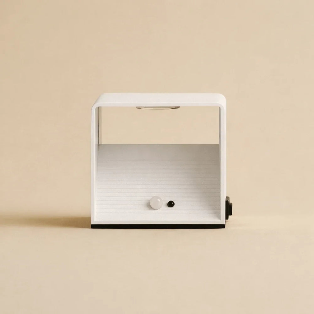Front view of the Cubo rechargeable wall light, showing the motion sensor and ribbed reflector inside the open face
