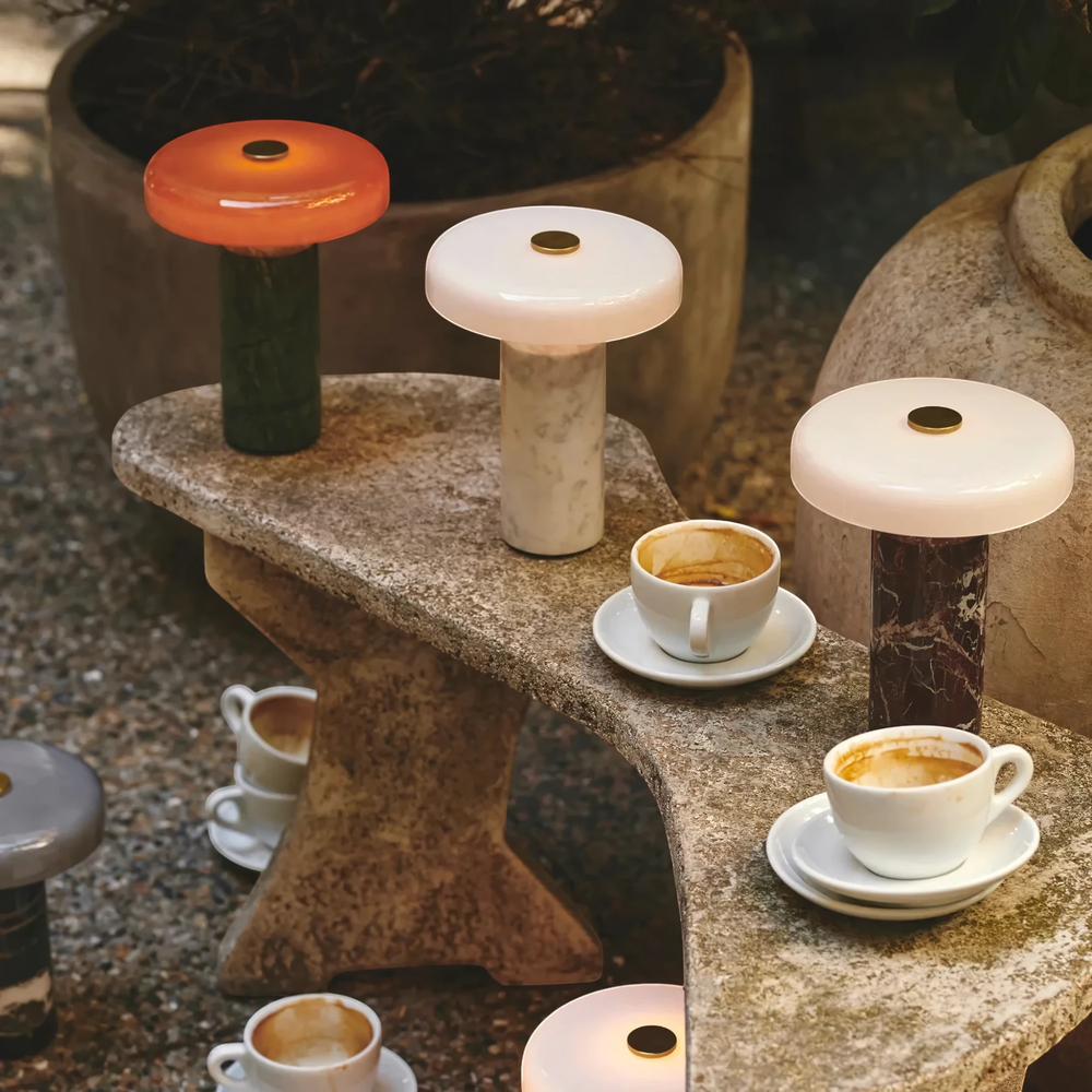Halo cordless table lamps in green, white and burgundy marble on a stone courtyard table, HALO-WHITE-01, HALO-GREEN-01, HALO-BLACK-01, HALO-BURG-01