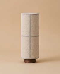 Washi table lamp with white fabric shade and walnut base, studio front view