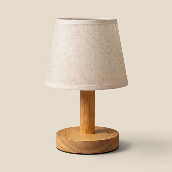 Vensalo Willow rechargeable table lamp with a rubberwood base and natural linen-blend shade, studio view