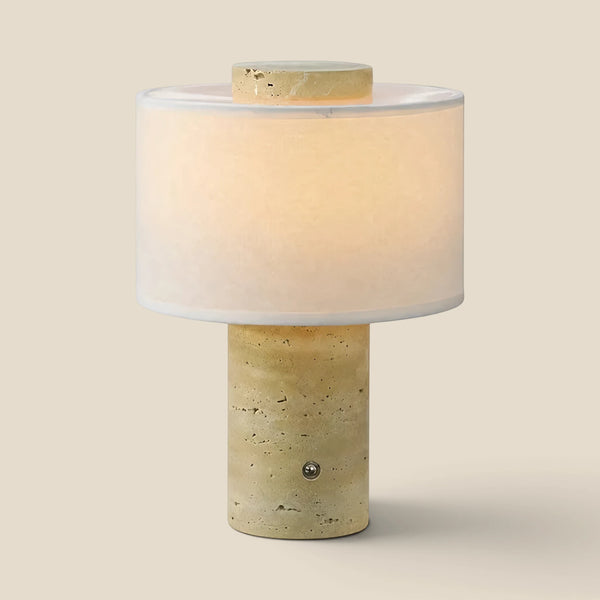 Vensalo Onyx Cloud rechargeable table lamp, travertine base with a linen drum shade, lit studio view