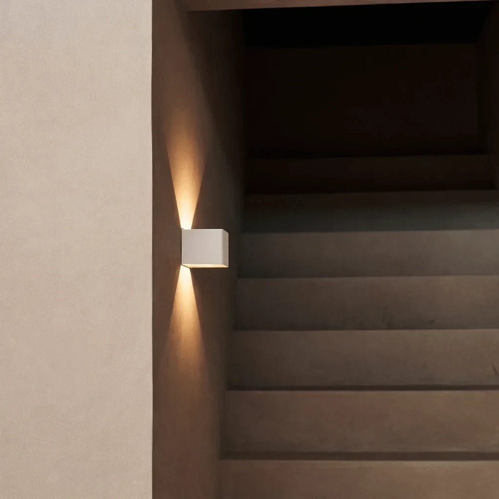 The Cubo mounted on a stairway wall with no wiring, lighting the steps below